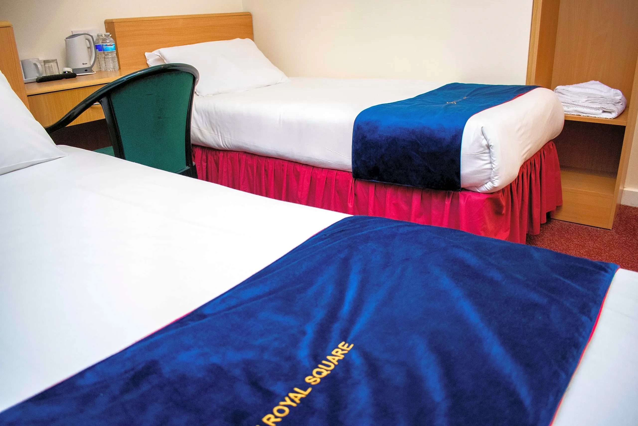 Classic Twin Room with two single beds made up with Royal Square throws